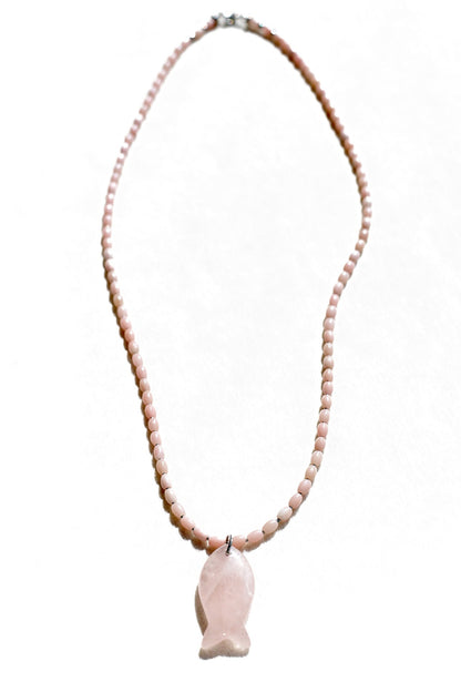 Necklace with pink beads and a fish-shaped pendant on a white background