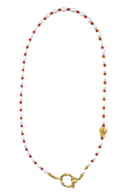 Necklace with white pearls, red beads, and gold clasp on a white background
